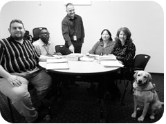 Contract Close-Out Specialist (CCS) Mike Fox, CCS Mike Eden, CCS Travis Cowsert, Contract Close-Out Supervisor Joyce Cozart, CCS Robyn Dunn and her guidedog Ms. Wanda