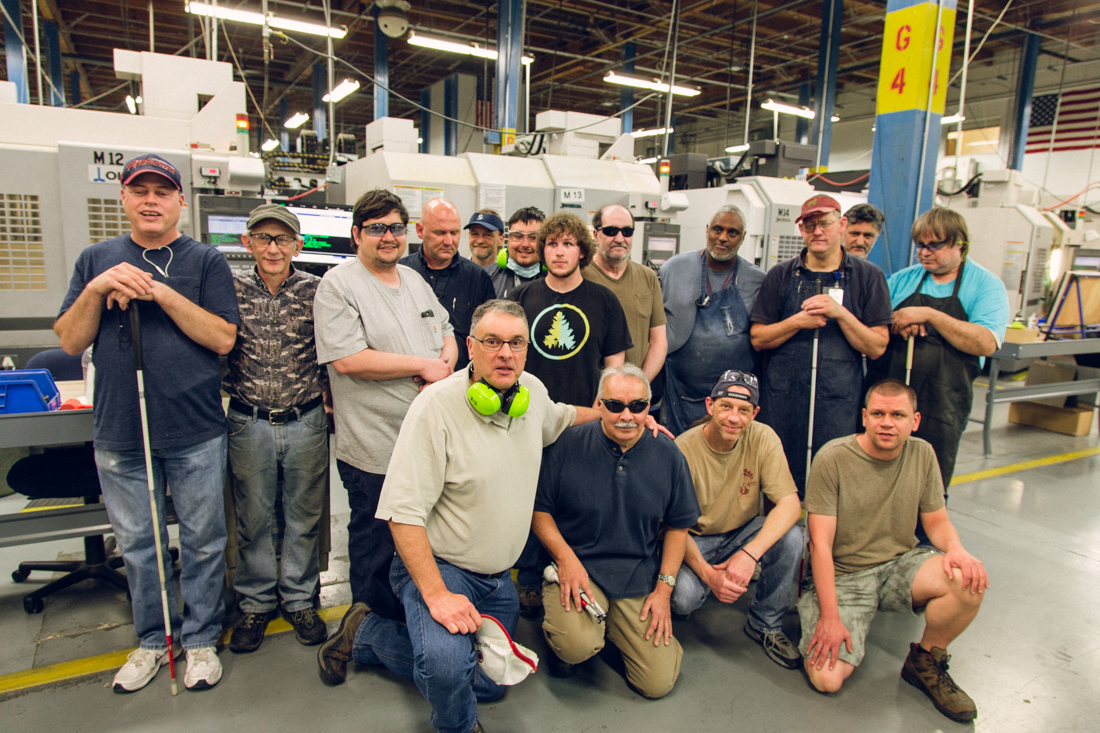 Group photo of machinists at the Lighthouse facility