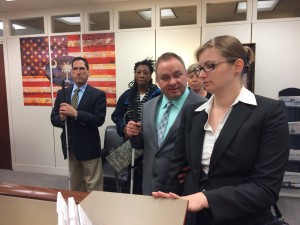 Lighthouse employees Robert Studebaker, Shawn Dobbs, and Paula Hoffman and a few others checking in to a meeting with an elected official.