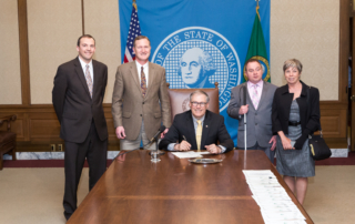 Governor Jay Inslee signing House Bill No. 2398 with Representatives Jeff Holy and Marcus Riccelli, and Lighthouse staff Shawn Dobbs and Paula Hoffman.