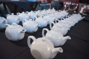 An array of tea kettles on a table, prepared for the event.