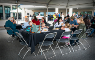 Community members sitting and enjoying delicious food from the food trucks at the event. (photos courtesy of Rick Diffley)