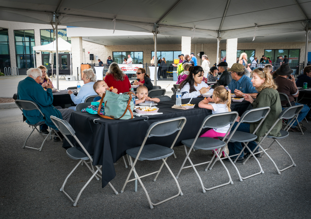 Community members sitting and enjoying delicious food from the food trucks at the event. (photos courtesy of Rick Diffley)