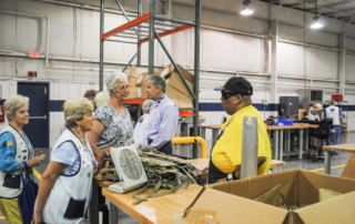 Members of the South Carolina Lions Club meet President and CEO Mike May (center right) and Lighthouse Proudction Workers at the Summerville One Year Anniversary