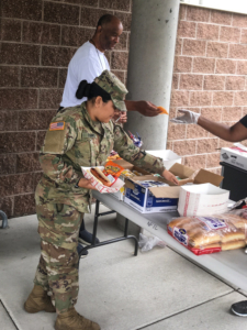 Woman in uniform buying food