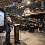 Guest speaker Richard Turner addresses the guests gathered in the Museum of Flight.