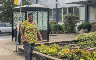 Meka White uses her white cane to navigate outside of the Seattle facility