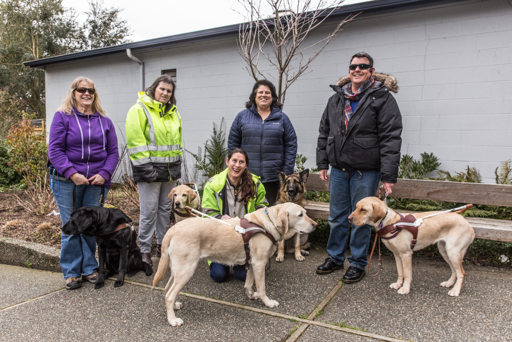 Group photo of Lighthouse employees with their guide dogs