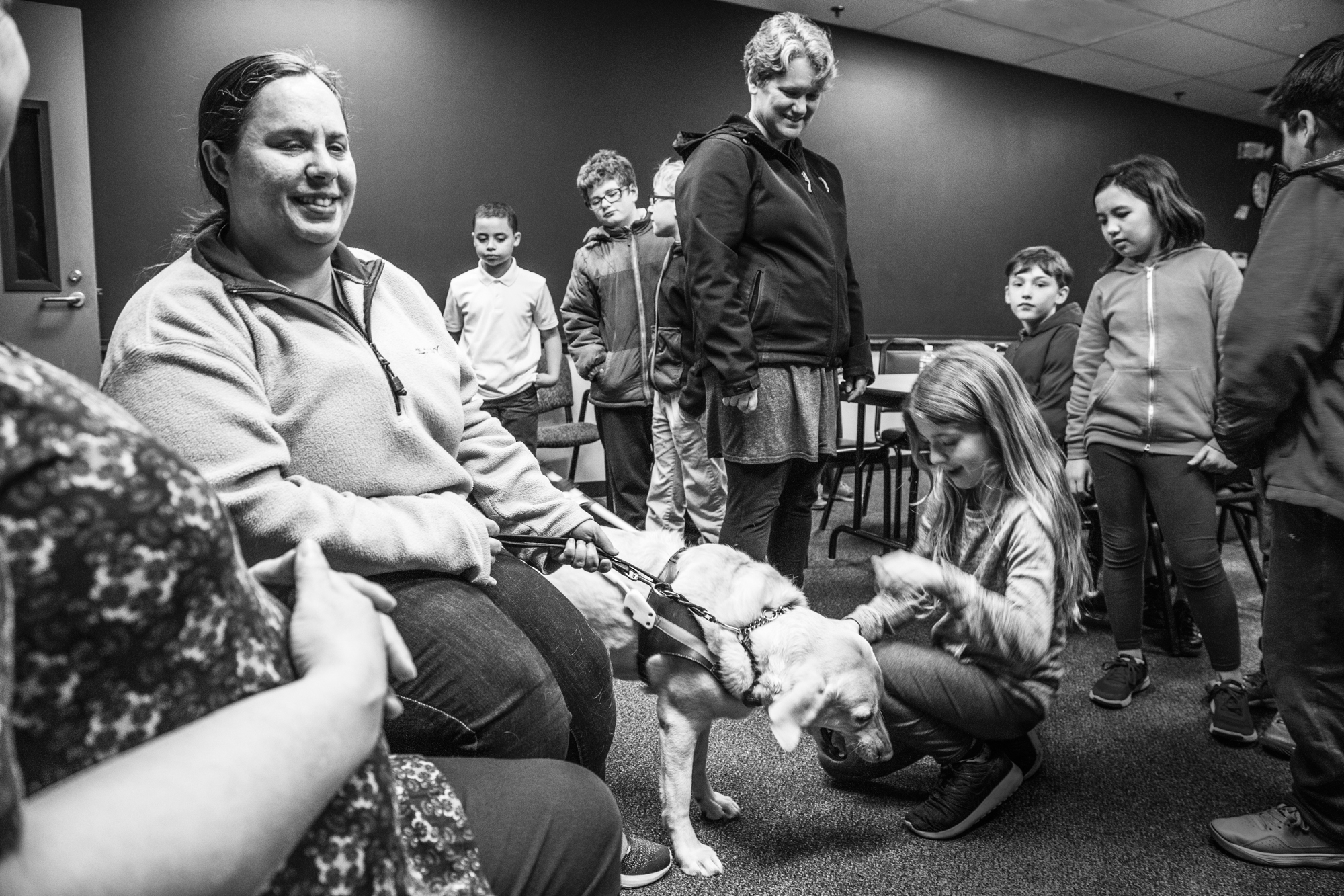 Lighthouse Production Worker Jolynn Page (left) introduces her guide dog during a School Tour. 