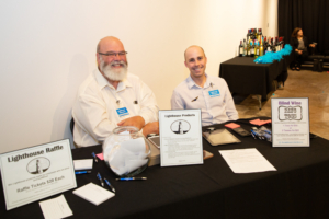 two men sitting at raffle table