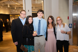 five people smiling for camera