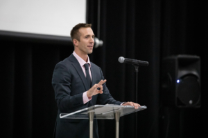 Man speaking at a podium