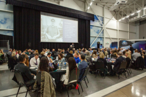 wide view of a room with people seated at tables