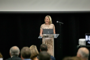 woman speaks at podium