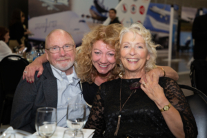 three people smiling for photo
