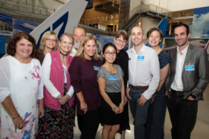 eight people pose for photo