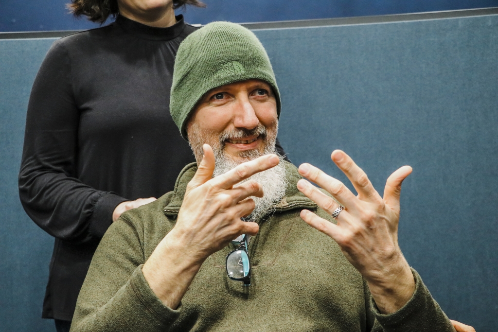 Close up photo of a man using sign language.