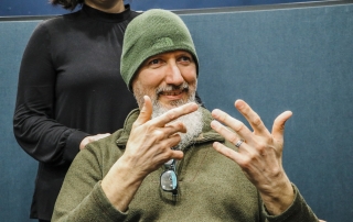 Close up photo of a man using sign language.