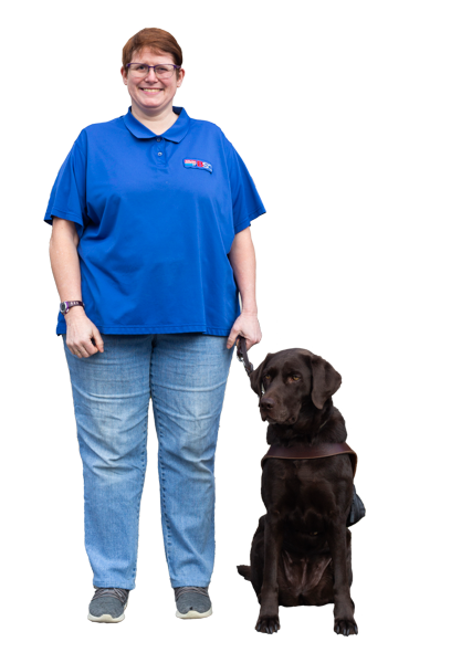 Colleen Smith, BSC Supply Clerk, a light skinned woman with red hair, stands with her dog guide beside her.