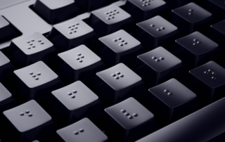 Close up of a computer keyboard with braille keys