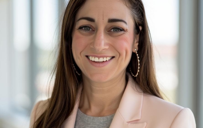 portrait shot of a light-skinned woman with long dark hair, smiling
