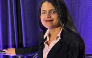 Aditi Shah - Foundation Board Member - stands looking at the camera, smiling