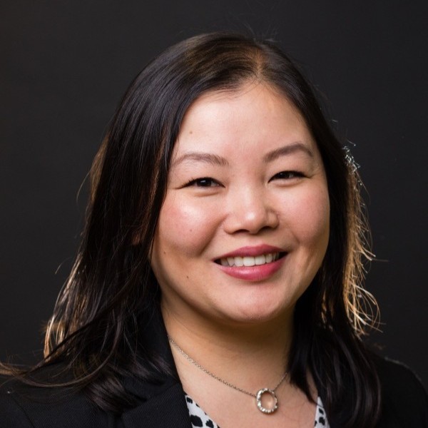 Portrait of Chang Liu smiling in a photo studio