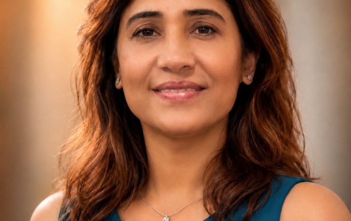 Portrait of a woman wearing a sleeveless shirt, with shoulder length brown hair