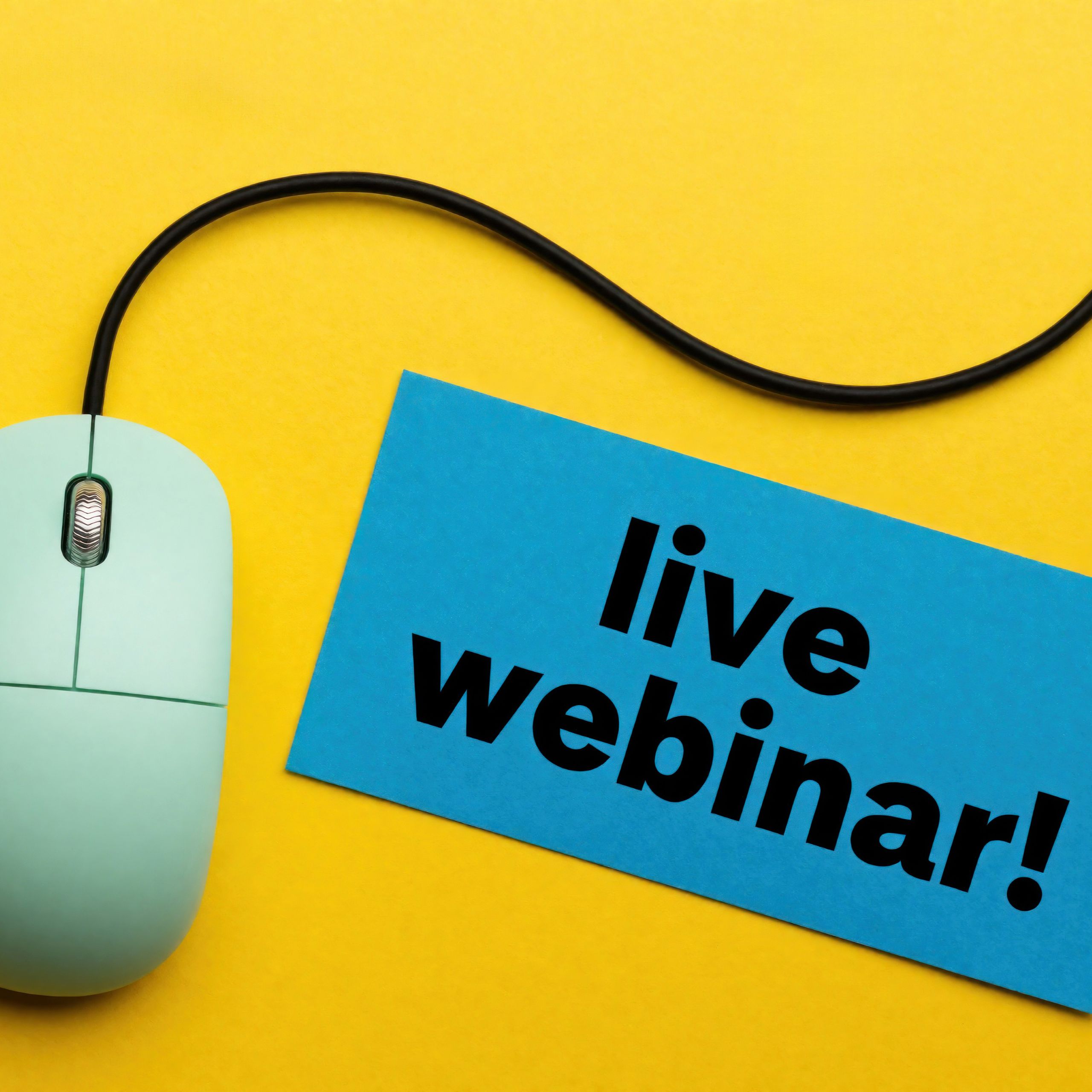 A green computer mouse with a sign that says, "live webinar"